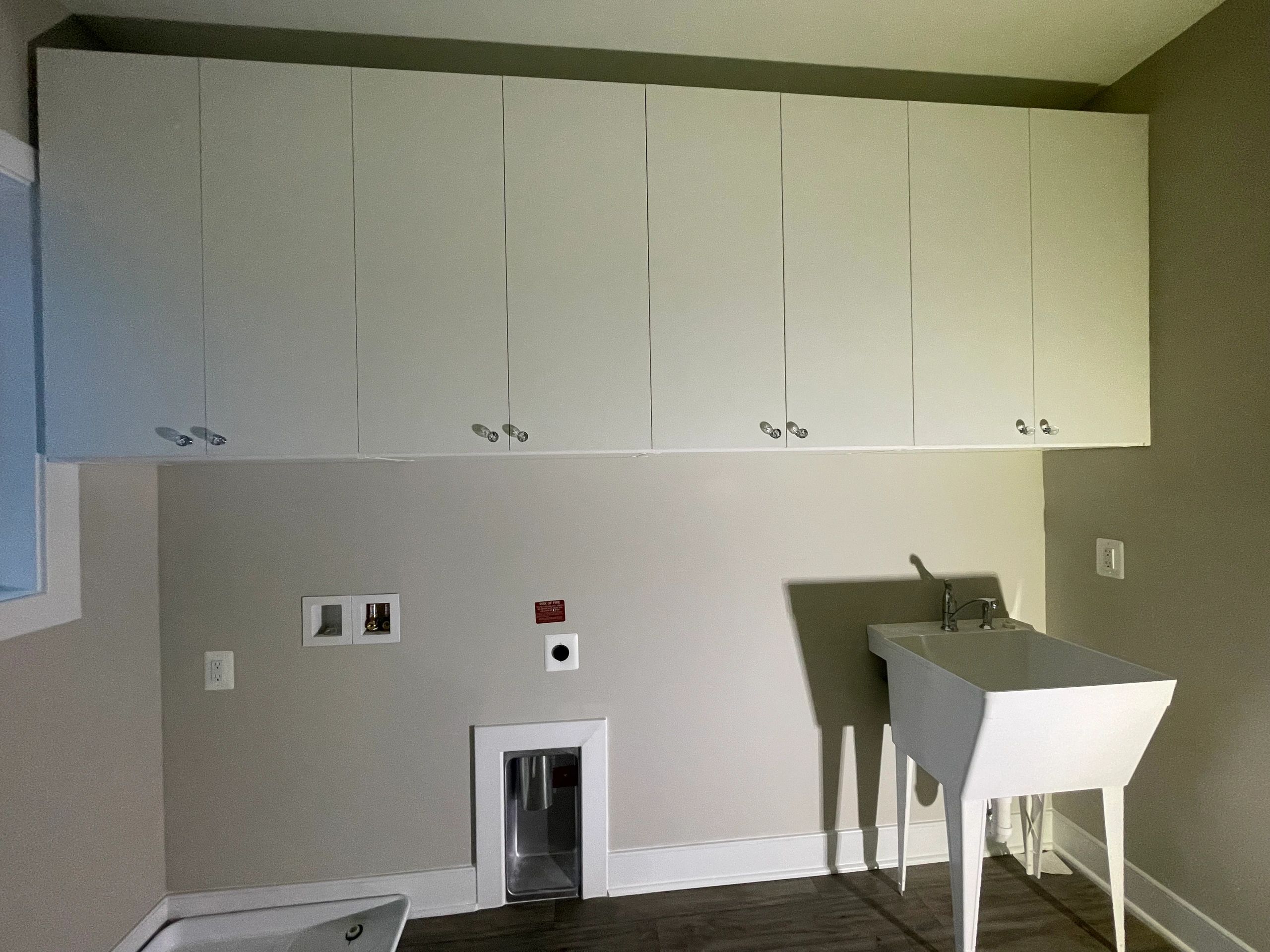 Laundry room storage overhead cabinets hanging space Fantasy Closets