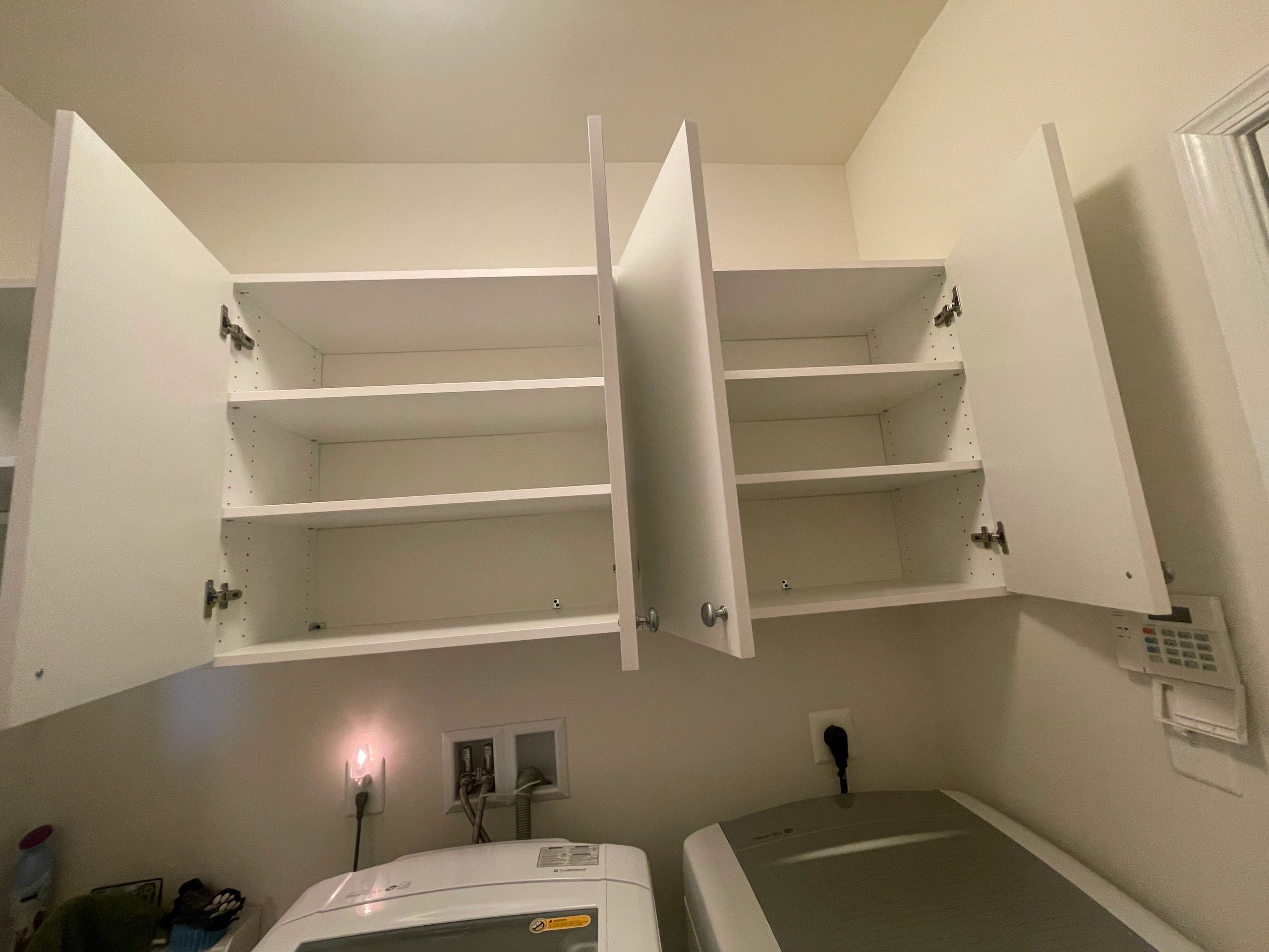 Laundry room organization white cabinets Fantasy Closets