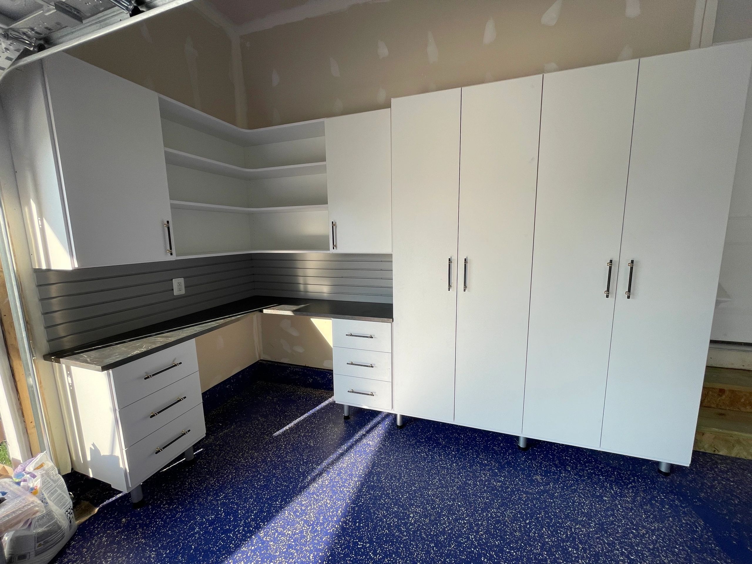 Custom garage storage white floor-to-ceiling cabinets Fantasy Closets