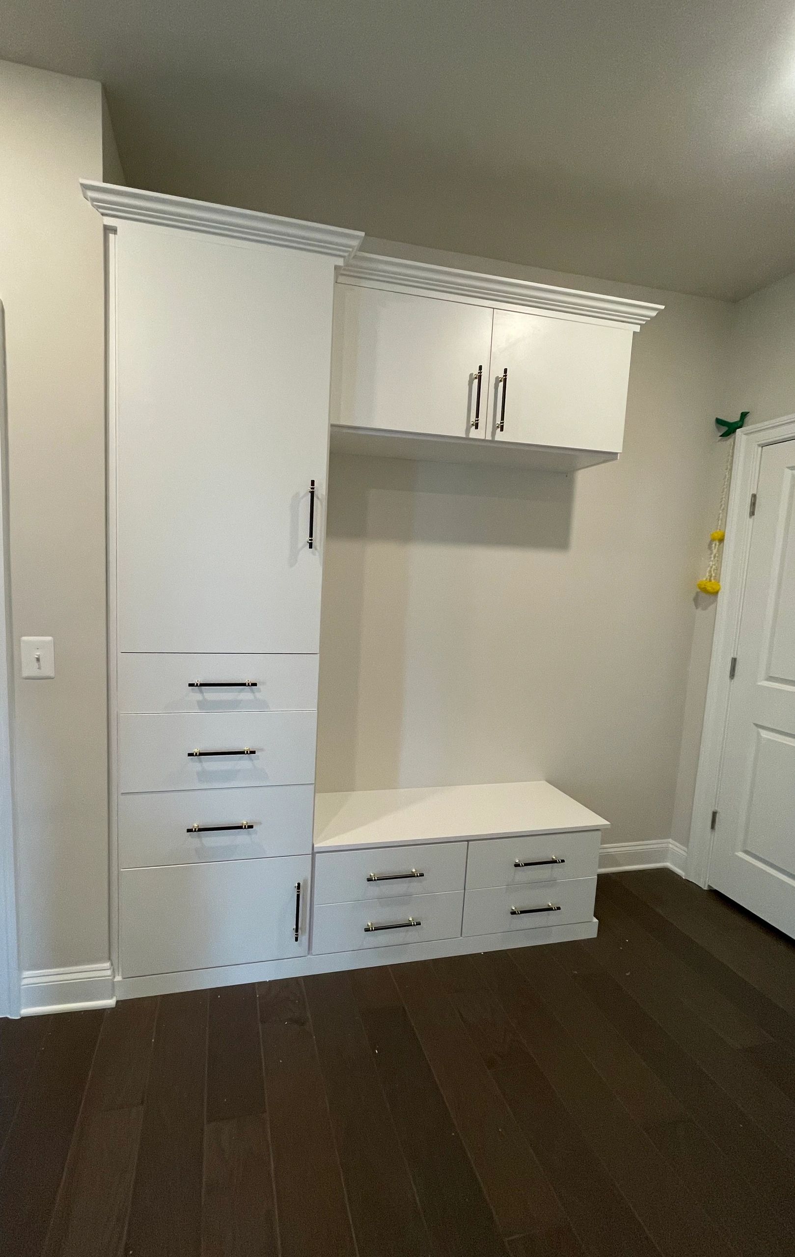 White built-in mudroom cabinets drawers silver handles Fantasy Closets