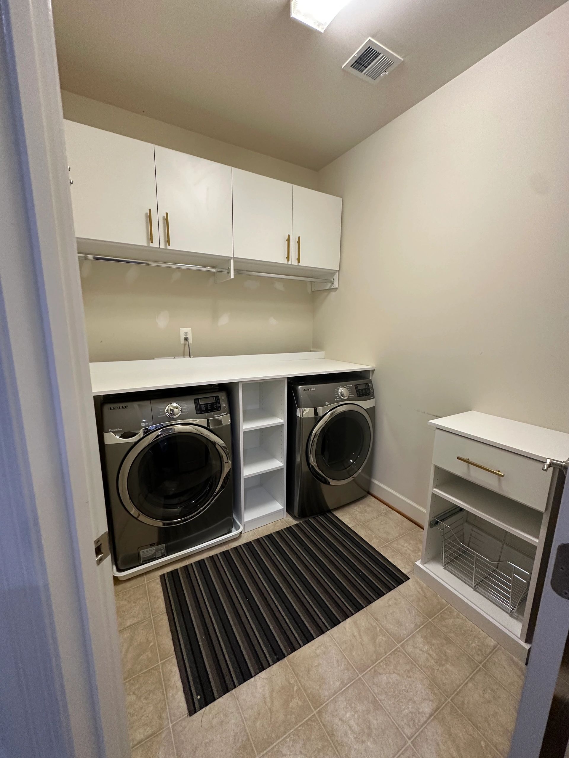 Laundry room organization built-in cabinets folding counter Fantasy Closets